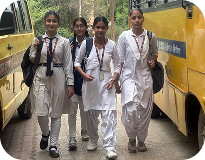 Students walking beside the school bus